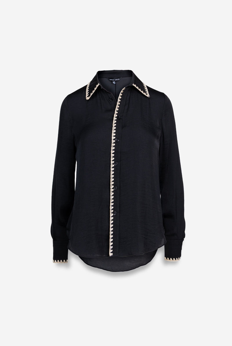 Black shirt with white trim on a light gray background